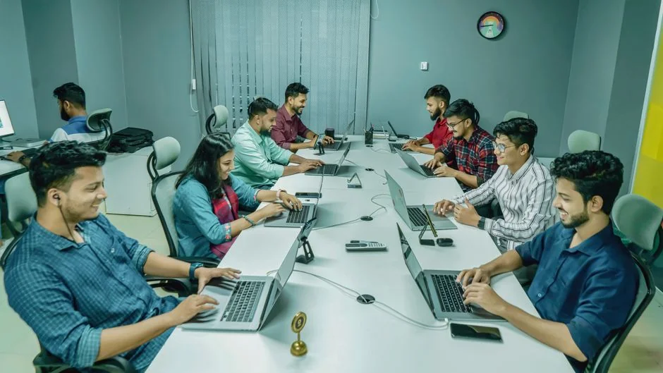 A modern workspace featuring dual computer monitors displaying web design projects, emphasizing technology and productivity.
